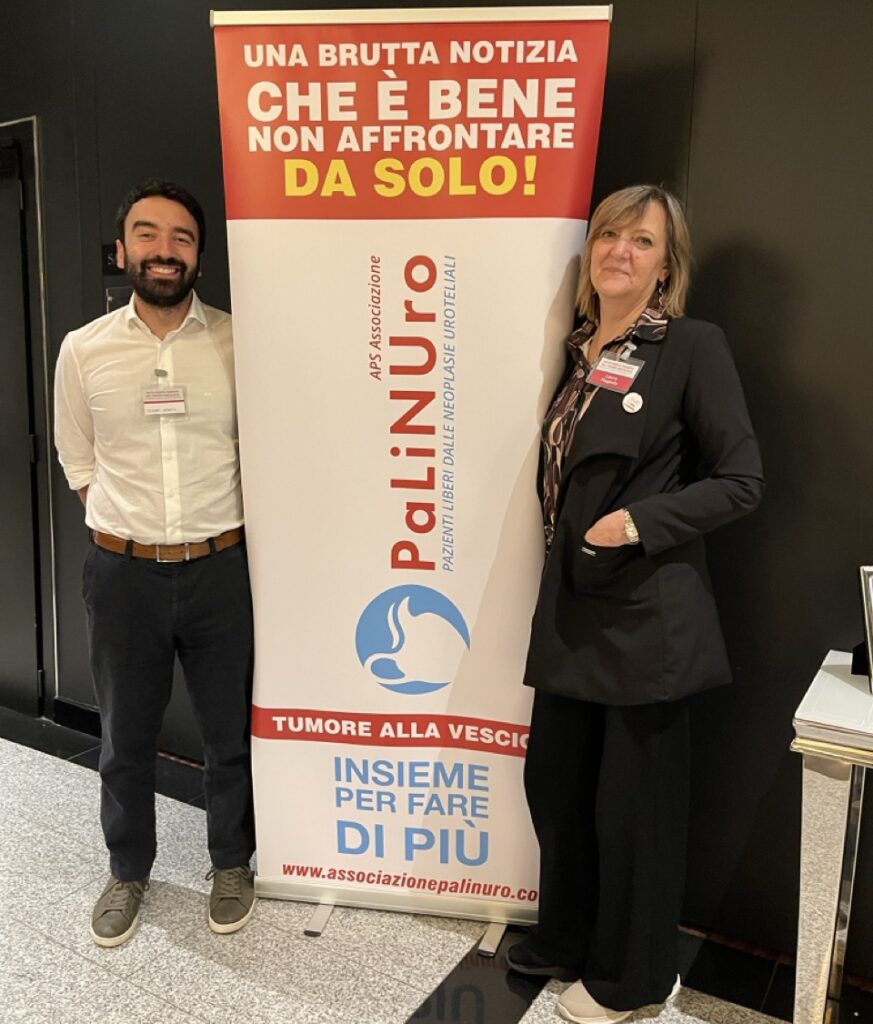 2 people standing next to the banner of congress